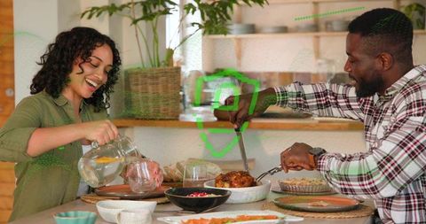 Couple Enjoying Cozy Home Dinner Woman Pouring Lemon Water Man Carving Roast Chicken and Pie