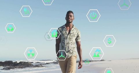 Man walking on beach with renewable energy icons concepts