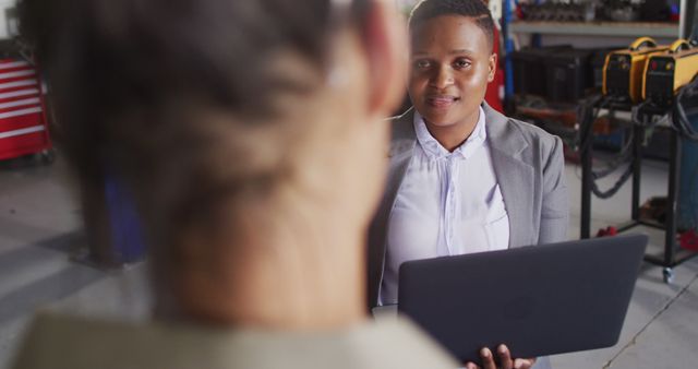 Businesswomen Having Discussion in Industrial Environment - Download Free Stock Images Pikwizard.com