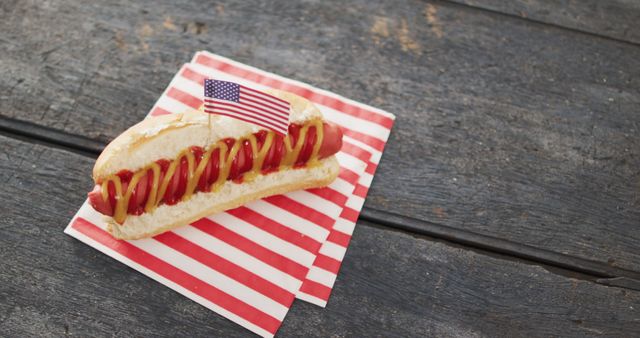 Image of hot dog with mustard and ketchup with flag of usa on a wooden surface - Download Free Stock Photos Pikwizard.com