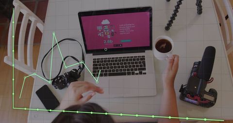 businesswoman analyzing data on laptop screen with graph overlay, depicting interaction with technology and data processing. this image is useful for illustrating concepts of data-driven decision making, analytics, and modern business strategies in digital marketing and financial analysis.