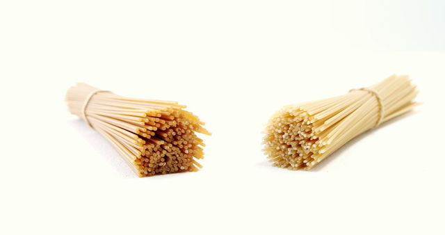 Two Bundles of Dry Spaghetti Isolated on White Background - Download Free Stock Images Pikwizard.com