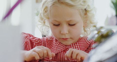 Focused Young Girl Engaged in Activity Indoors