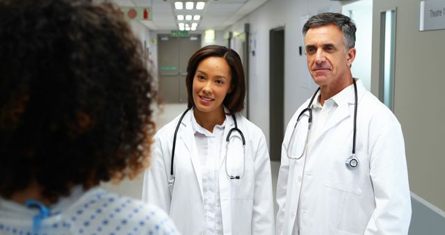 Doctors Consulting Patient in Hospital Corridor - Download Free Stock Images Pikwizard.com