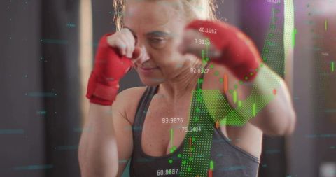 Female boxer punching with red hand wraps overlaid with stock market data visualization