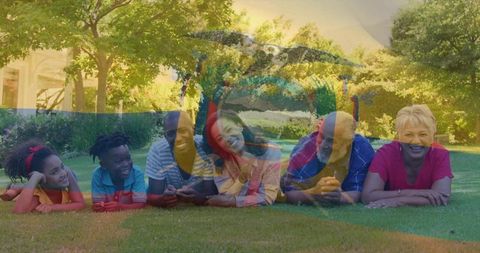 Multigenerational family relaxing on sunlit lawn, smiling in casual clothes with color overlay