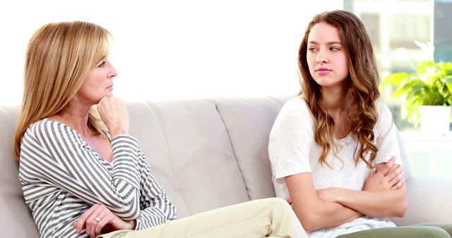 Teenage Girl and Mother in Serious Conversation on Couch - Download Free Stock Images Pikwizard.com