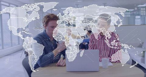 Team collaborating on laptop with world map overlay showing global network and connectivity