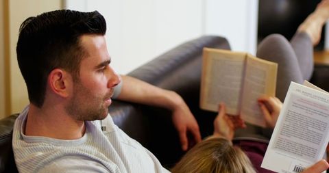 Couple Relaxing on Sofa Enjoying Books at Home - Download Free Stock Images Pikwizard.com