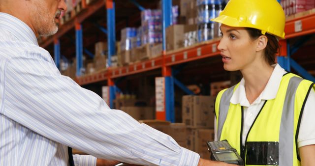 Warehouse Manager Discussing Work Plans with Compliance Officer - Download Free Stock Images Pikwizard.com