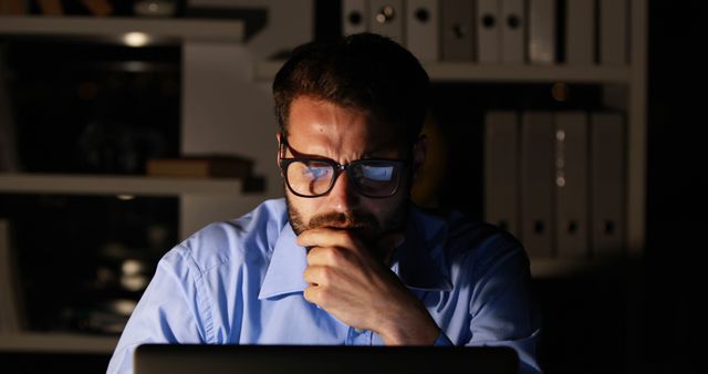 Focused Man Working Late on Laptop at Home Office - Download Free Stock Images Pikwizard.com