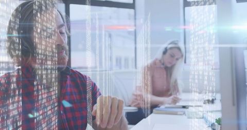 Office workers engaged in digital data management with holographic screens