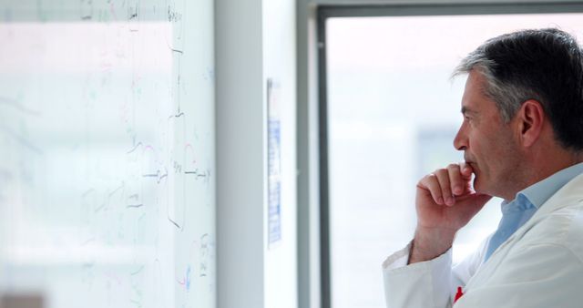 Male Scientist Deep in Thought Analyzing Whiteboard in Lab - Download Free Stock Images Pikwizard.com