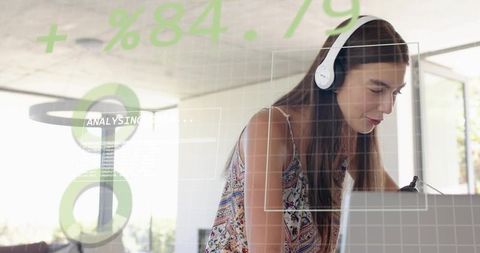 Leaning woman wearing white headset typing on laptop with data hud overlays