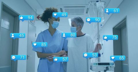 Nurse aiding patient with iv infusion in hospital corridor