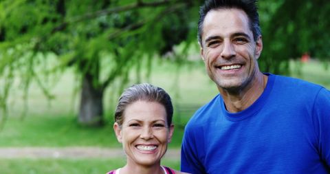 Smiling Middle-aged Couple in Athletic Wear Outdoors - Download Free Stock Images Pikwizard.com