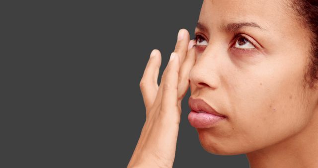 Makeup Artist Applying Cream to Model's Face Against Grey Background - Download Free Stock Images Pikwizard.com