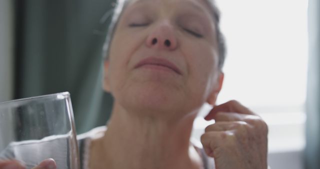 Elderly Woman Refreshing Herself with Water - Download Free Stock Images Pikwizard.com