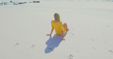 Woman in Yellow Dress Relaxing on Tranquil Ocean Beach - Download Free Stock Images Pikwizard.com
