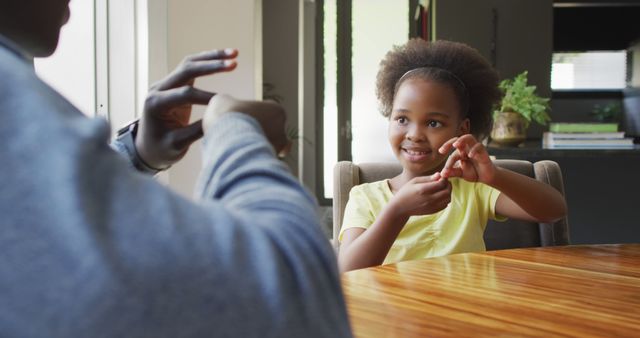 Little Girl Learning Sign Language with Adult at Home - Download Free Stock Images Pikwizard.com