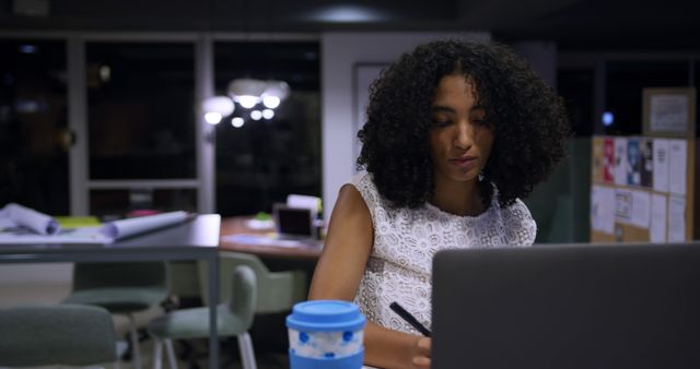 Focused Woman Working Late on Laptop in Modern Office - Download Free Stock Images Pikwizard.com