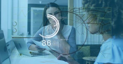 Women Reviewing Documents with Augmented Reality HUD Dashboard and Laptop in Office