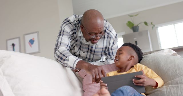 Grandfather and grandson bonding over tablet at home - Download Free Stock Images Pikwizard.com