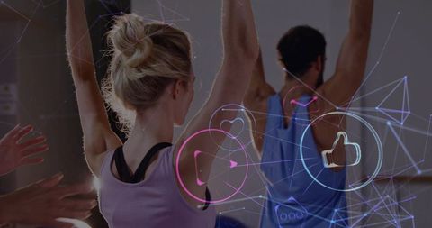 Mid-adult woman stretching at barre with augmented reality fitness overlays