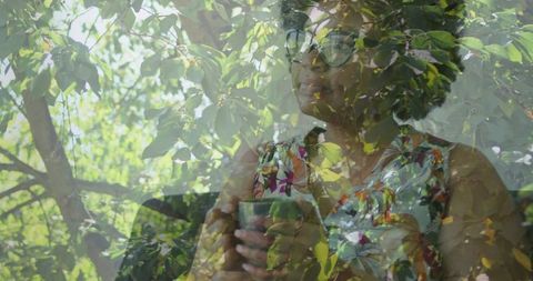 Woman contemplating through cafe window with nature reflection