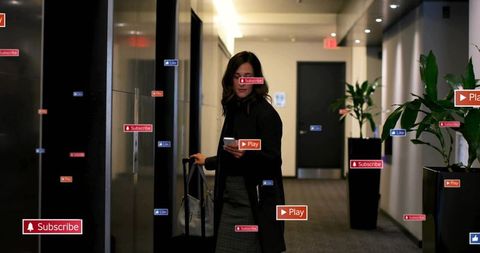 Business traveler holding phone with suitcase in hotel corridor and floating ui icons
