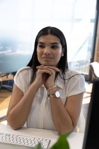 Pensive woman in modern office with minimalist decor