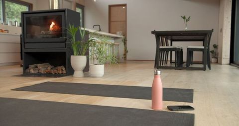 Cozy Home Yoga Space with Mats by Warm Fireplace