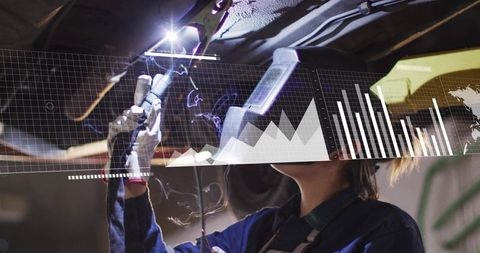 Woman Welder Repairing Vehicle Undercarriage with HUD Data Overlay and Welding Sparks