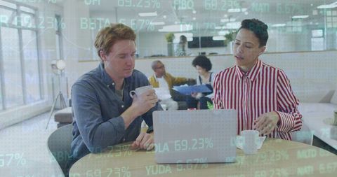 Diverse Coworkers Analyzing Financial Data in Modern Office