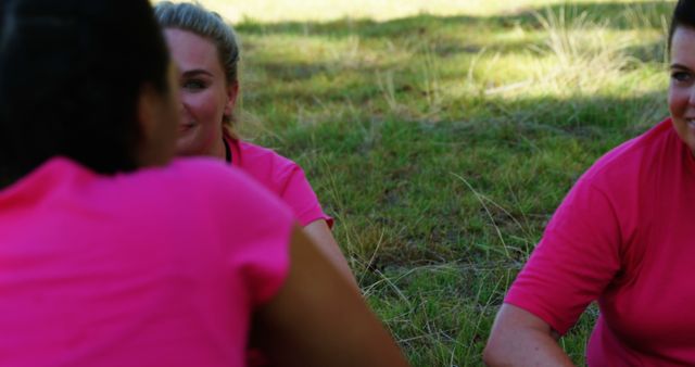Women in Pink Shirts Enjoying Outdoor Conversation on Grass - Download Free Stock Images Pikwizard.com