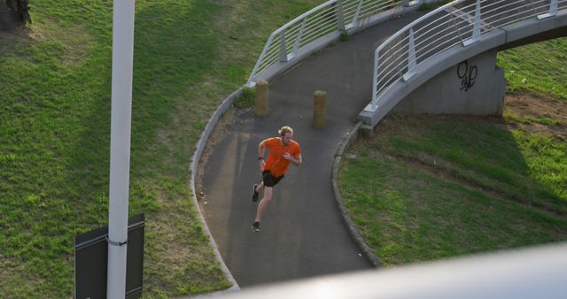 Man Running on Curved Bridge Path in Urban Park - Download Free Stock Images Pikwizard.com