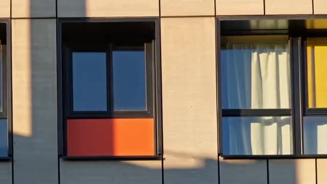 Modern Building Facade with Colorful Panels and Windows