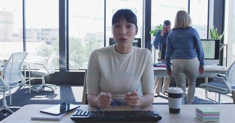 Focused Woman Typing at Modern Office Desk with Technology