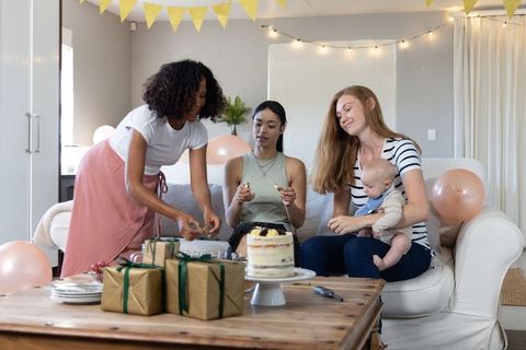 Diverse Group of Women and Baby Celebrating Together at Home