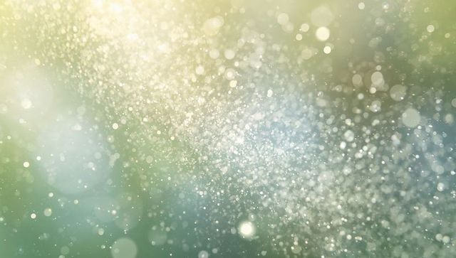 Shimmering light particles drifting through sunlit foliage with bokeh and ethereal glow