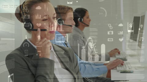 Call Center Team Analyzing Data with Headsets at Desks