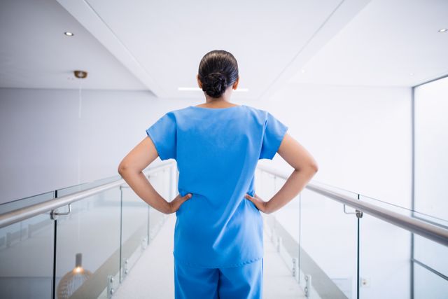Confident Nurse Standing in Hospital Corridor - Download Free Stock Photos Pikwizard.com
