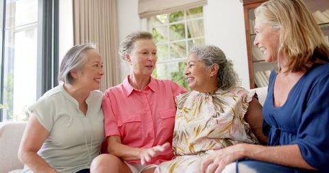 Senior Friends Engaged in Lively Conversation at Home