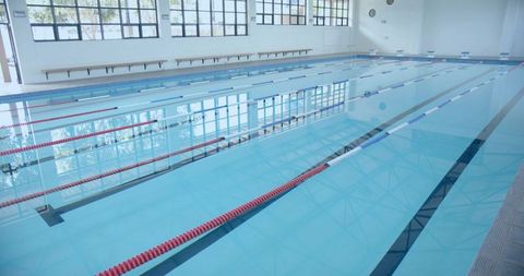 Empty lap pool in bright indoor wellness center