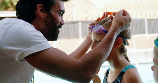 Swim Coach Adjusting Young Swimmer’s Goggles by Pool - Download Free Stock Images Pikwizard.com