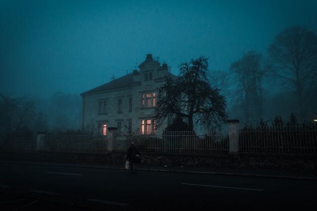 Mysterious House at Dusk with Faint Lights Through Fog - Download Free Stock Photos Pikwizard.com