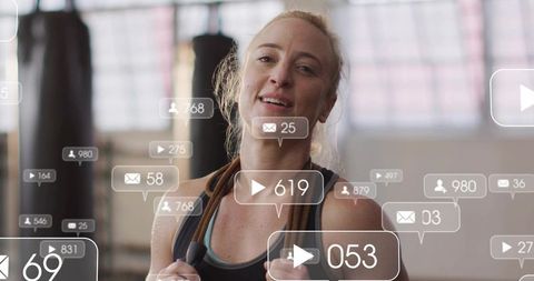 Female athlete training with resistance bands in sunlit gym with social media overlays