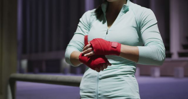 Female Boxer Wrapping Hands with Red Bandages in Urban Setting - Download Free Stock Images Pikwizard.com