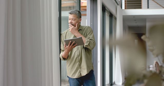 Pensive Man with Beard Holding Tablet and Writing - Download Free Stock Images Pikwizard.com