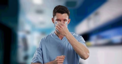 Healthcare professional adjusting face mask in hospital environment